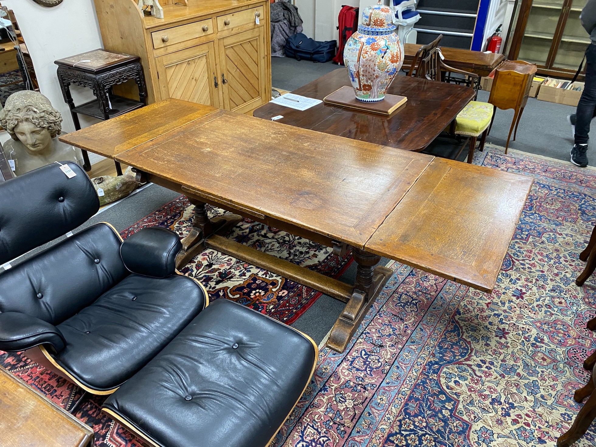 A 1930's oak draw leaf dining table, length 136cm, width 83cm, height 74cm